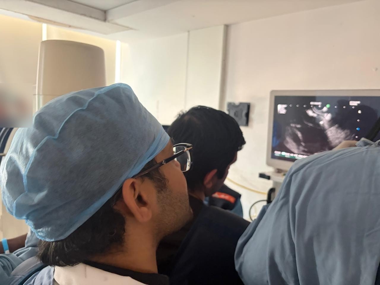 Gastroenterology team watching the endoscopic ultrasound monitor during EUS-guided gallbladder drainage